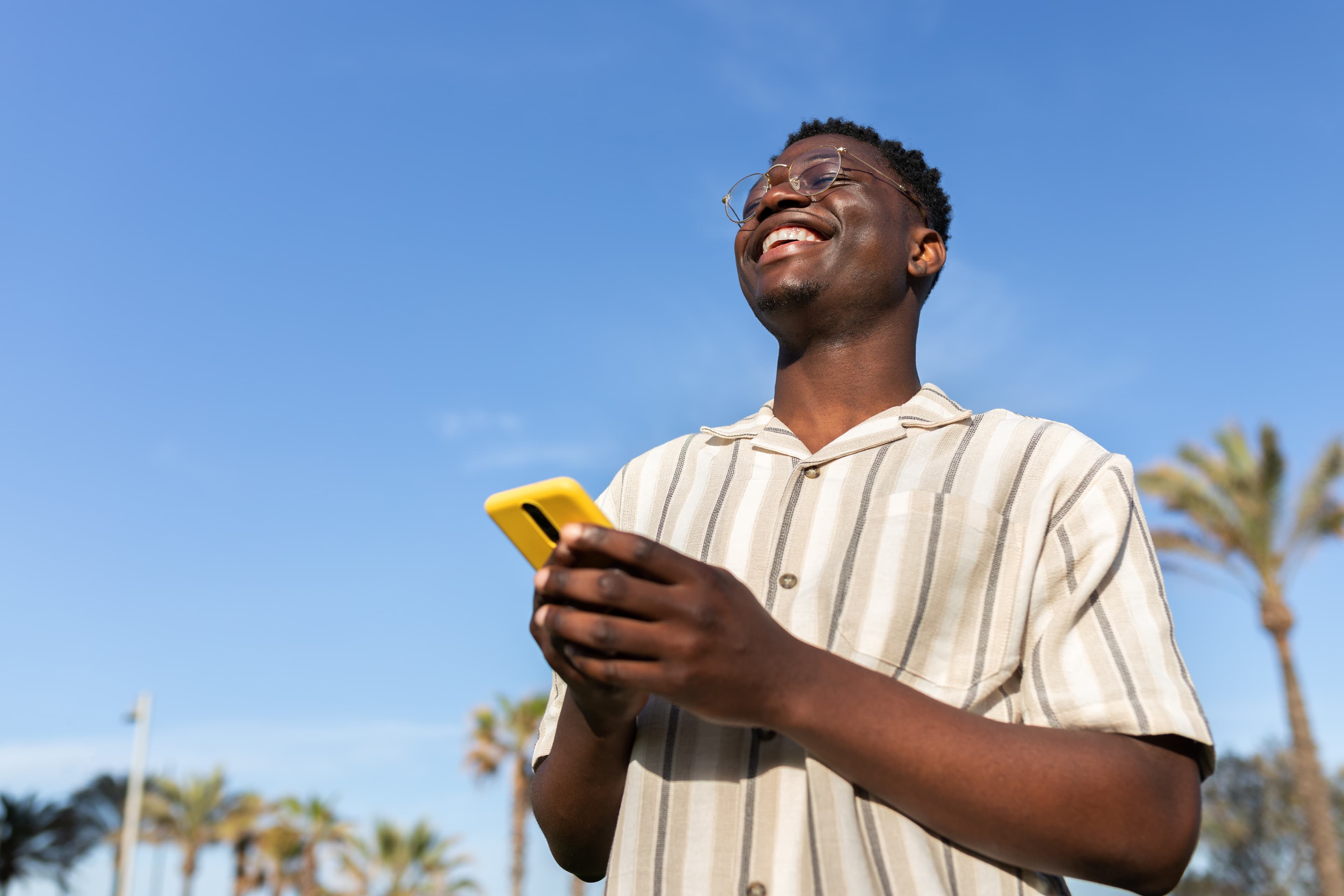 Person smiling while using their phone